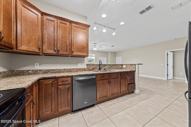 kitchen featuring appliances with stainless steel finishes, a sink, a ceiling fan, light tile patterned flooring, and brown cabinetry