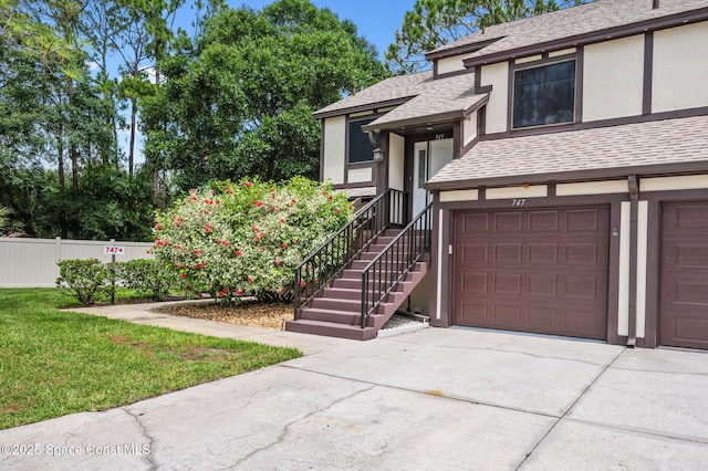 747 Greenwood Manor Cir Unit 17-A, West Melbourne, FL 32904 - view of front facade with stucco siding, driveway, and roof with shingles