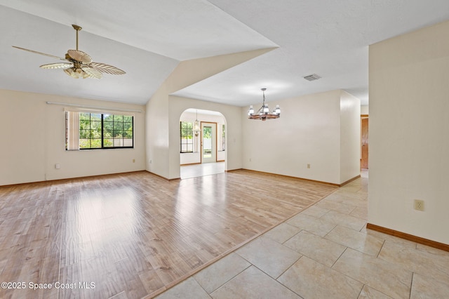 747 Greenwood Manor Cir Unit 17-A, West Melbourne, FL 32904 - spare room with a chandelier, arched walkways, ceiling fan, and lofted ceiling