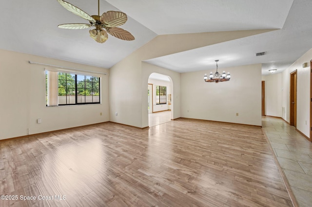747 Greenwood Manor Cir Unit 17-A, West Melbourne, FL 32904 - unfurnished room with a chandelier, lofted ceiling, arched walkways, light wood-type flooring, and ceiling fan