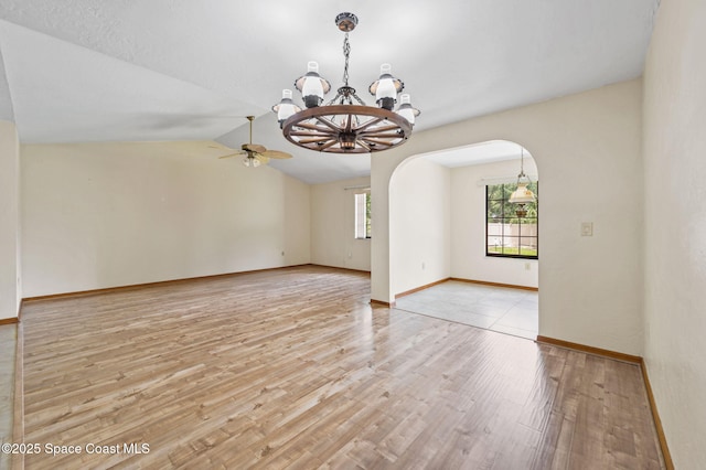 747 Greenwood Manor Cir Unit 17-A, West Melbourne, FL 32904 - unfurnished room featuring a chandelier, light wood finished floors, arched walkways, ceiling fan, and vaulted ceiling