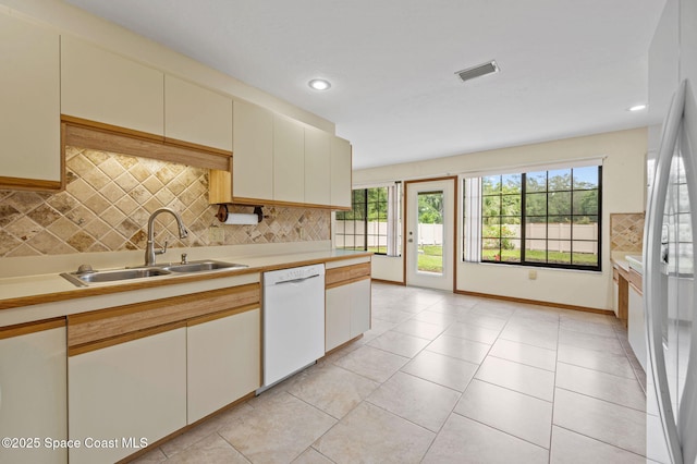 747 Greenwood Manor Cir Unit 17-A, West Melbourne, FL 32904 - kitchen with dishwasher, light countertops, plenty of natural light, tasteful backsplash, and recessed lighting