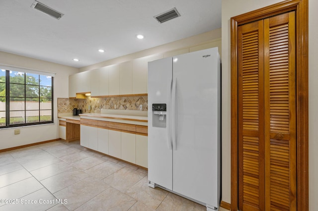 747 Greenwood Manor Cir Unit 17-A, West Melbourne, FL 32904 - kitchen featuring white refrigerator with ice dispenser, light countertops, tasteful backsplash, white cabinetry, and recessed lighting