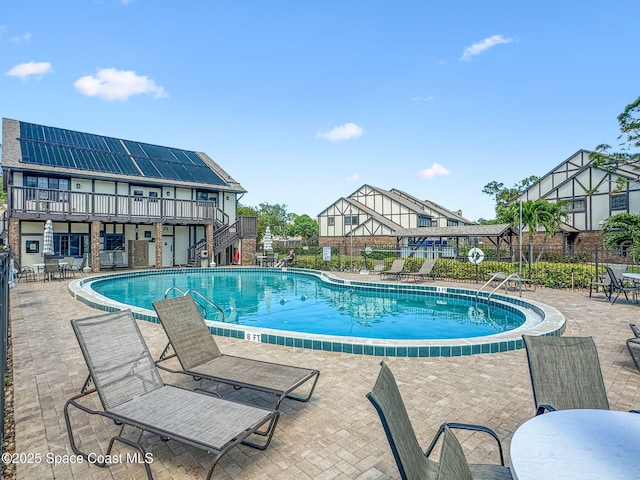 747 Greenwood Manor Cir Unit 17-A, West Melbourne, FL 32904 - community pool with stairs, a patio area, and a wooden deck