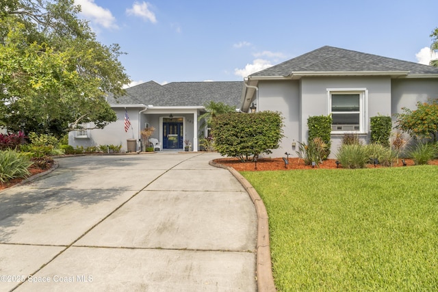 1035 Quail Ct SW, Vero Beach, FL 32968 - view of front of home with roof with shingles, driveway, a front lawn, and stucco siding