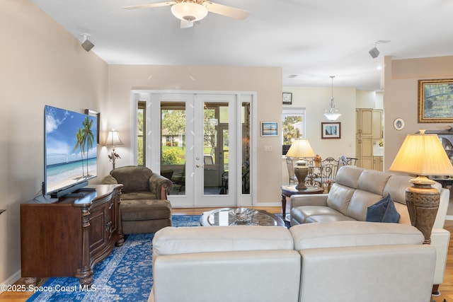 1035 Quail Ct SW, Vero Beach, FL 32968 - living room featuring ceiling fan, french doors, wood finished floors, and baseboards
