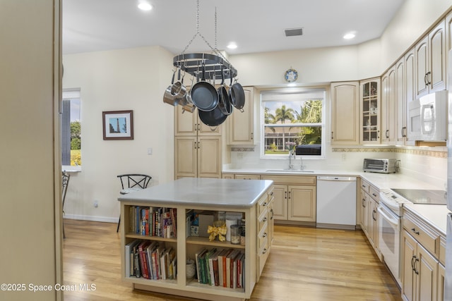 1035 Quail Ct SW, Vero Beach, FL 32968 - kitchen with white appliances, a sink, light wood-type flooring, decorative backsplash, and recessed lighting