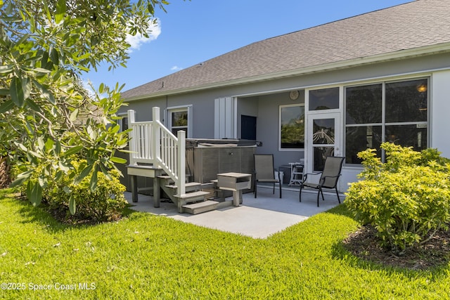 1035 Quail Ct SW, Vero Beach, FL 32968 - back of house featuring a hot tub, a patio area, a shingled roof, and a yard