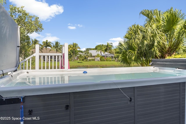 1035 Quail Ct SW, Vero Beach, FL 32968 - view of swimming pool with a hot tub