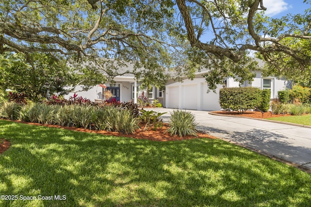1035 Quail Ct SW, Vero Beach, FL 32968 - view of property hidden behind natural elements featuring an attached garage, driveway, stucco siding, and a front yard