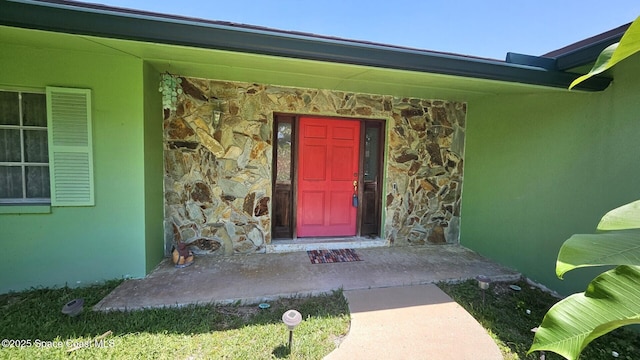 306 Glen Ridge Rd, Cocoa, FL 32926 - property entrance featuring stone siding and stucco siding