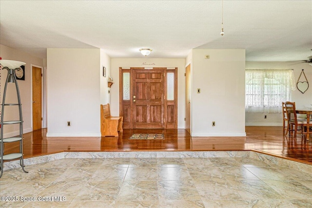 306 Glen Ridge Rd, Cocoa, FL 32926 - foyer featuring baseboards, ceiling fan, and marble finish floors