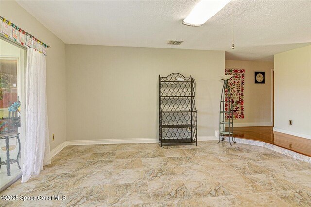 306 Glen Ridge Rd, Cocoa, FL 32926 - spare room featuring stone finish flooring and baseboards