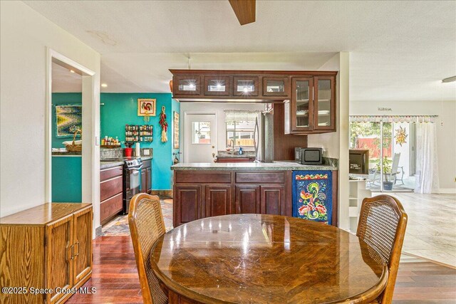 306 Glen Ridge Rd, Cocoa, FL 32926 - dining area with healthy amount of natural light and dark wood finished floors
