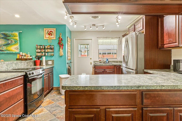 306 Glen Ridge Rd, Cocoa, FL 32926 - kitchen featuring stainless steel fridge, black electric range, light stone finish floors, a peninsula, and a sink
