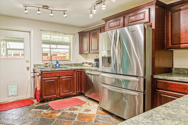306 Glen Ridge Rd, Cocoa, FL 32926 - kitchen with stainless steel appliances, a sink, and stone finish floors