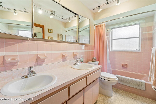 306 Glen Ridge Rd, Cocoa, FL 32926 - full bath with toilet, shower / bath combo with shower curtain, tile walls, speckle patterned floor, and tasteful backsplash