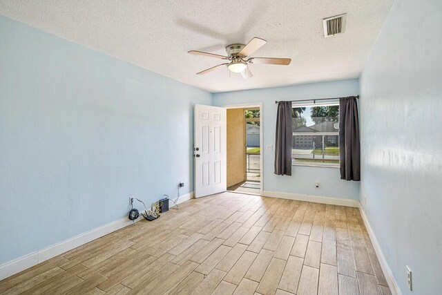 517 Fulton St, Daytona Beach, FL 32114 - empty room featuring ceiling fan, wood finished floors, a textured ceiling, and baseboards