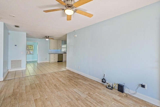 517 Fulton St, Daytona Beach, FL 32114 - unfurnished living room with ceiling fan, light wood finished floors, baseboards, and a sink