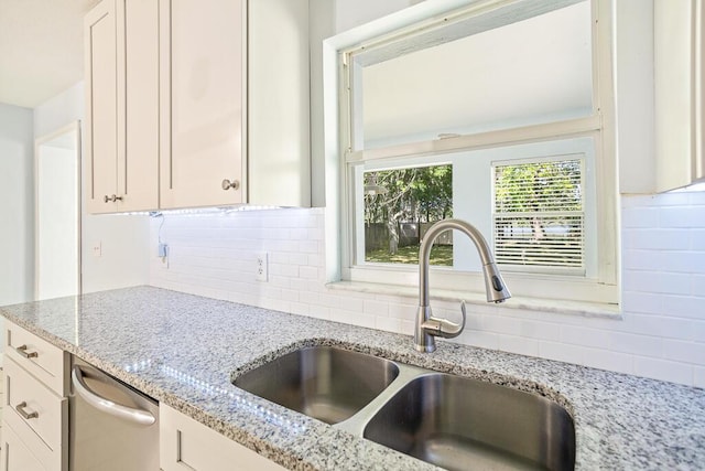 517 Fulton St, Daytona Beach, FL 32114 - kitchen with a sink, decorative backsplash, and light stone countertops