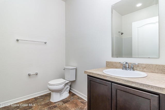 122 Port Royal Cir, Sebastian, FL 32958 - bathroom featuring baseboards, toilet, vanity, and stone finish floors