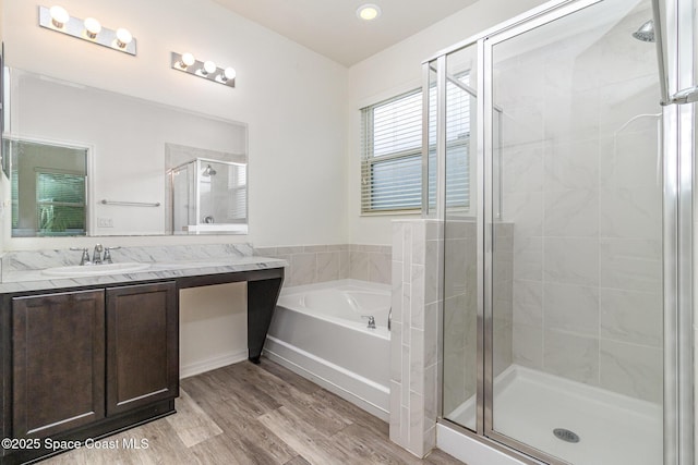 122 Port Royal Cir, Sebastian, FL 32958 - full bath featuring a shower stall, a garden tub, vanity, wood finished floors, and recessed lighting