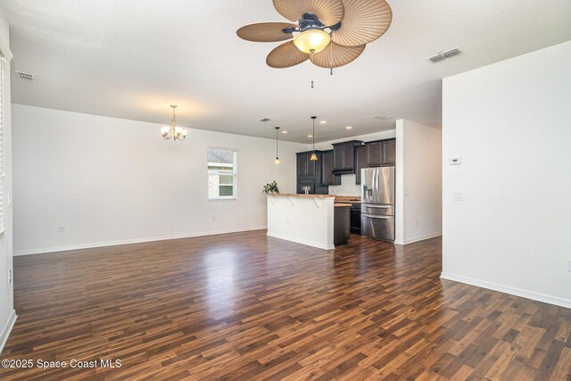 122 Port Royal Cir, Sebastian, FL 32958 - unfurnished living room with dark wood finished floors, ceiling fan, a chandelier, baseboards, and recessed lighting