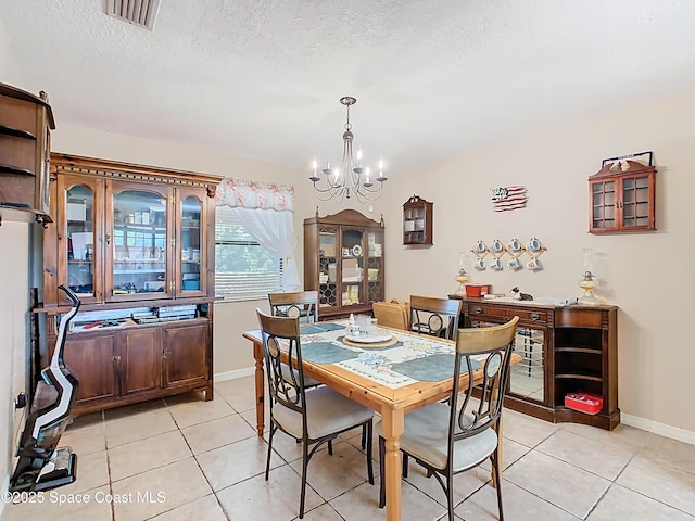4432 Freedom Rd, Kissimmee, FL 34746 - dining area featuring a chandelier, light tile patterned floors, baseboards, and a textured ceiling