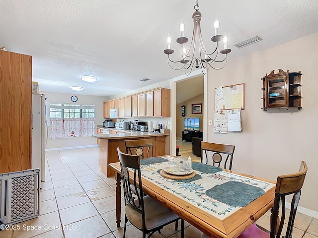 4432 Freedom Rd, Kissimmee, FL 34746 - dining area featuring light tile patterned flooring, a chandelier, baseboards, and a textured ceiling