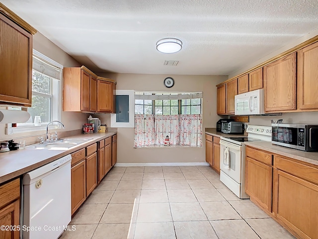 4432 Freedom Rd, Kissimmee, FL 34746 - kitchen with white appliances, a sink, light countertops, light tile patterned floors, and a textured ceiling