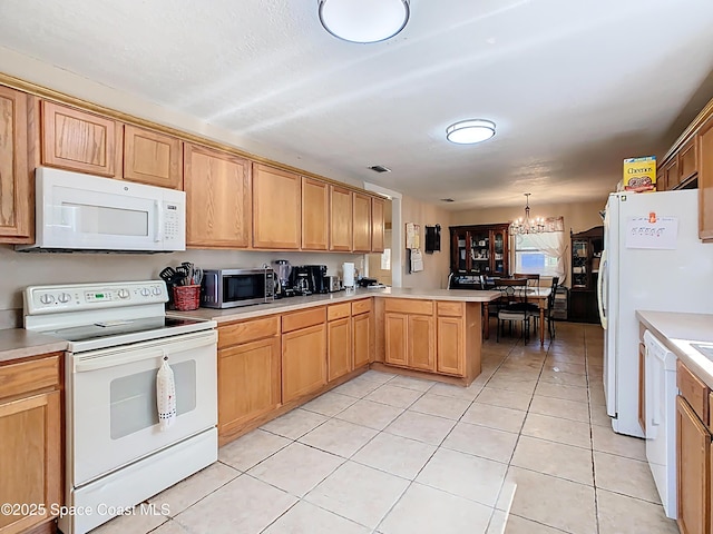 4432 Freedom Rd, Kissimmee, FL 34746 - kitchen with white appliances, a peninsula, a chandelier, light countertops, and light tile patterned floors