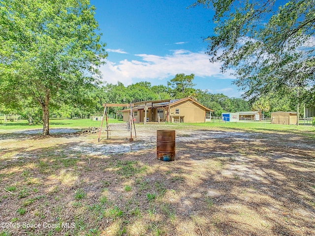 4432 Freedom Rd, Kissimmee, FL 34746 - view of front facade with an outdoor structure and view of scattered trees