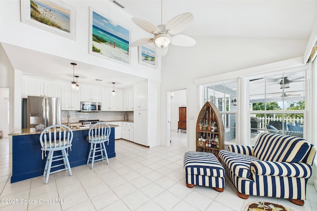 2945 70th Pl, Vero Beach, FL 32967 - living area with ceiling fan, high vaulted ceiling, and light tile patterned floors