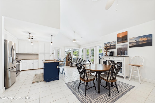 2945 70th Pl, Vero Beach, FL 32967 - dining area featuring ceiling fan, light tile patterned floors, and high vaulted ceiling