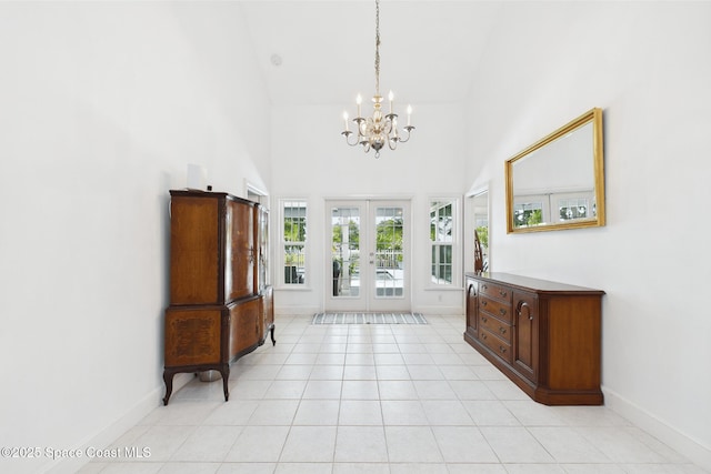 2945 70th Pl, Vero Beach, FL 32967 - foyer entrance featuring french doors, a chandelier, high vaulted ceiling, baseboards, and light tile patterned floors