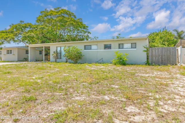 1049 Azalea Ln, Cocoa, FL 32922 - view of front facade featuring fence and stucco siding