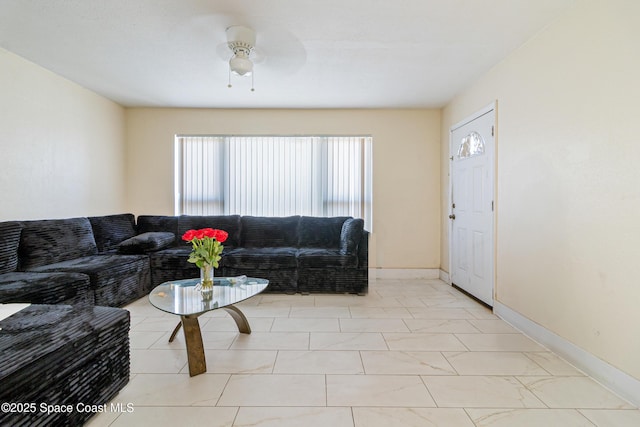 1049 Azalea Ln, Cocoa, FL 32922 - living room featuring a ceiling fan and baseboards