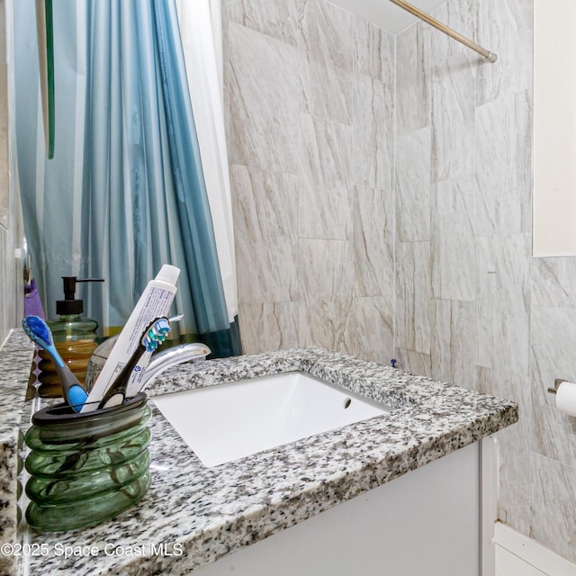 1049 Azalea Ln, Cocoa, FL 32922 - bathroom with vanity, curtained shower, and tile walls