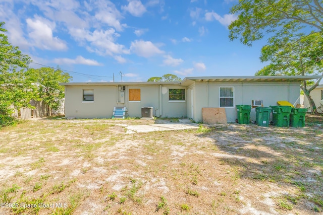 1049 Azalea Ln, Cocoa, FL 32922 - rear view of house featuring cooling unit and stucco siding