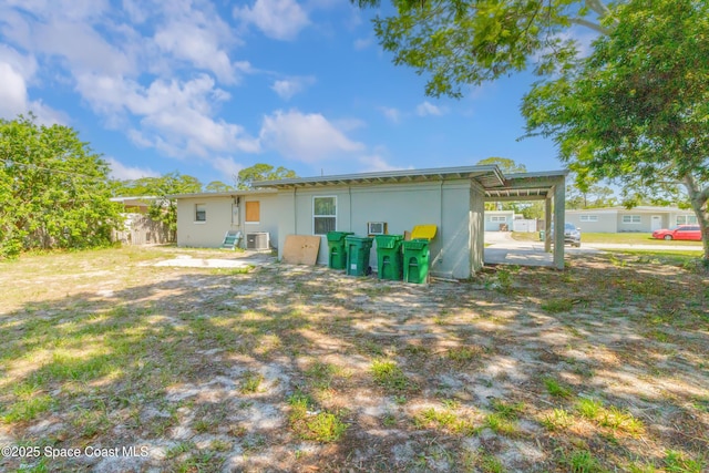 1049 Azalea Ln, Cocoa, FL 32922 - back of house with central AC unit and stucco siding