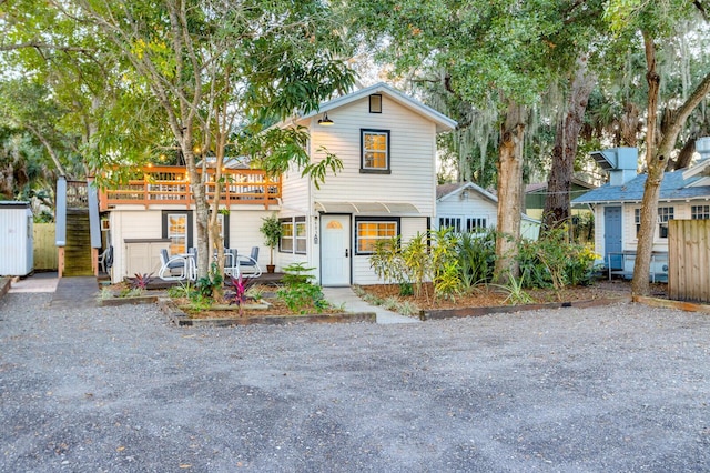 view of front of property with a wooden deck and stairs