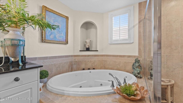 480 Sail Ln Unit 607, Merritt Island, FL 32953 - full bath featuring a tub with jets, vanity, and a shower stall