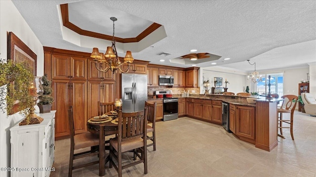 480 Sail Ln Unit 607, Merritt Island, FL 32953 - kitchen featuring a chandelier, appliances with stainless steel finishes, a raised ceiling, crown molding, and a textured ceiling