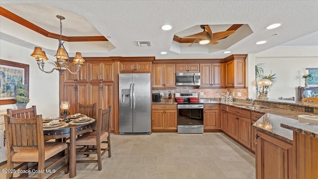 480 Sail Ln Unit 607, Merritt Island, FL 32953 - kitchen with stainless steel appliances, a tray ceiling, ornamental molding, a chandelier, and tasteful backsplash