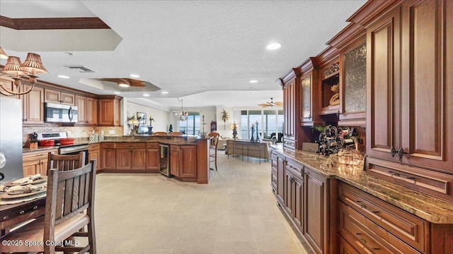 480 Sail Ln Unit 607, Merritt Island, FL 32953 - kitchen with stainless steel appliances, beverage cooler, a breakfast bar area, a peninsula, and crown molding
