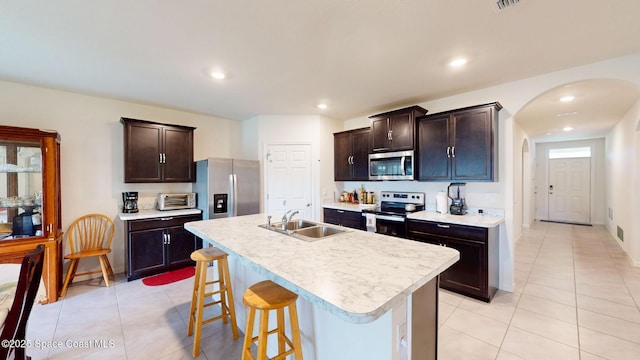 1491 Higbee St SE, Palm Bay, FL 32909 - kitchen with appliances with stainless steel finishes, a sink, light countertops, arched walkways, and recessed lighting