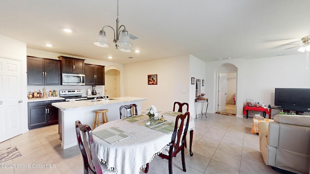 1491 Higbee St SE, Palm Bay, FL 32909 - dining room with arched walkways, light tile patterned floors, a chandelier, recessed lighting, and a ceiling fan