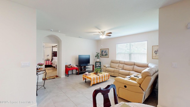 1491 Higbee St SE, Palm Bay, FL 32909 - living area featuring ceiling fan, arched walkways, light tile patterned flooring, and baseboards