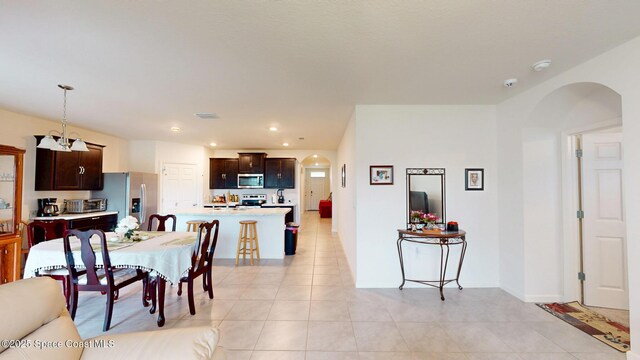 1491 Higbee St SE, Palm Bay, FL 32909 - dining room with arched walkways, light tile patterned flooring, baseboards, and recessed lighting