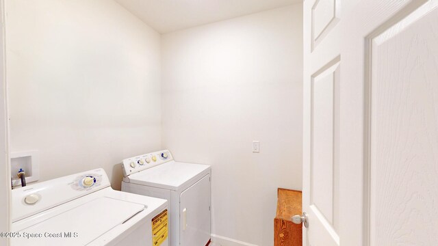 1491 Higbee St SE, Palm Bay, FL 32909 - washroom featuring washing machine and dryer and baseboards